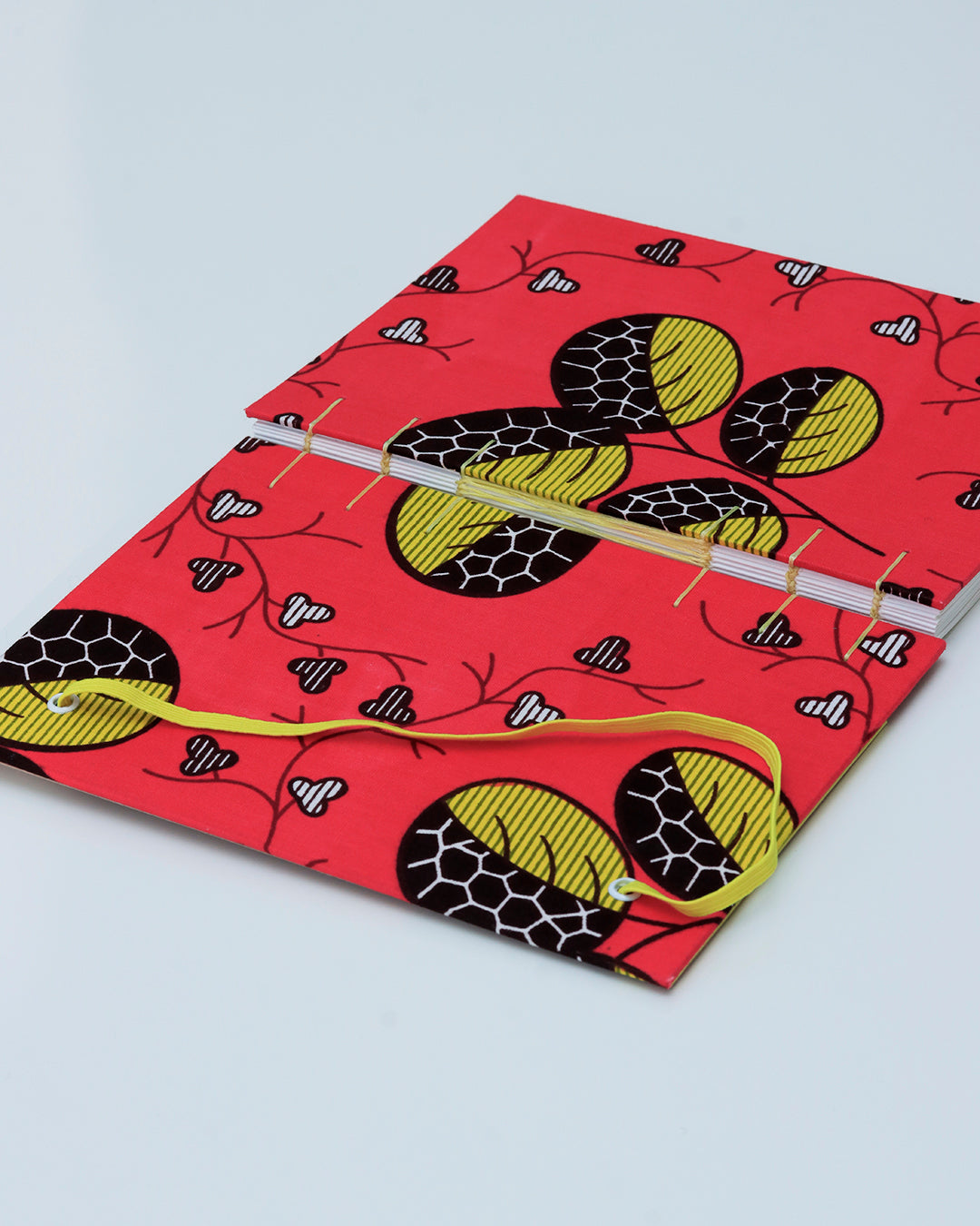 Quaderno A5 wax africano foglie fucsia e giallo (elastico e busta)